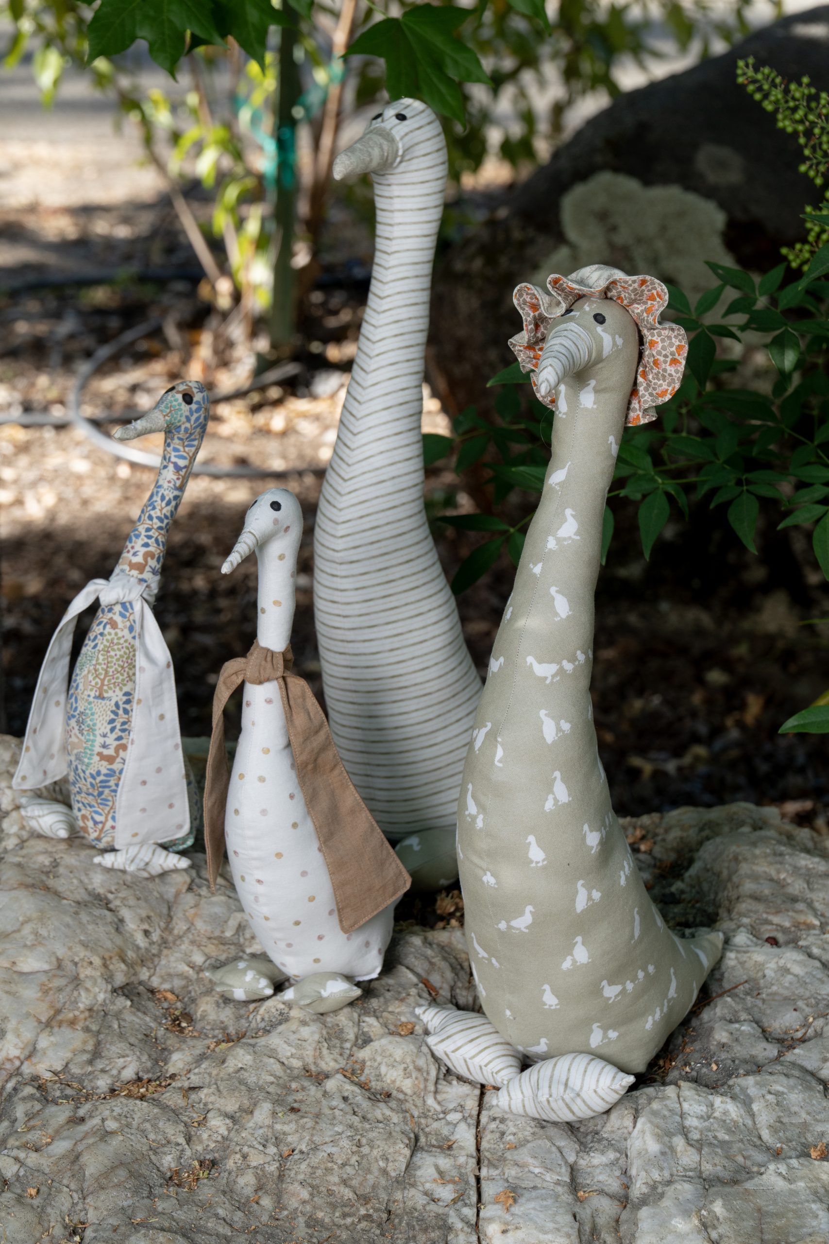 Handmade fabric goose figures displayed outdoors