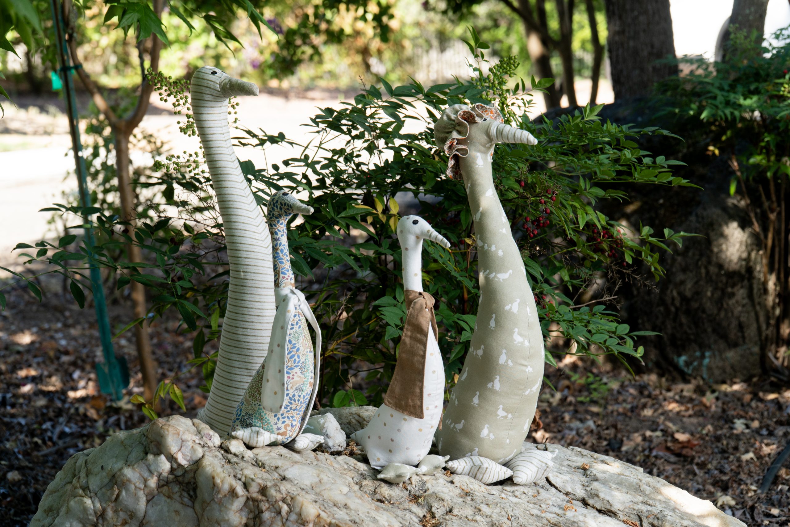 Handmade fabric goose figures displayed outdoors, second angle